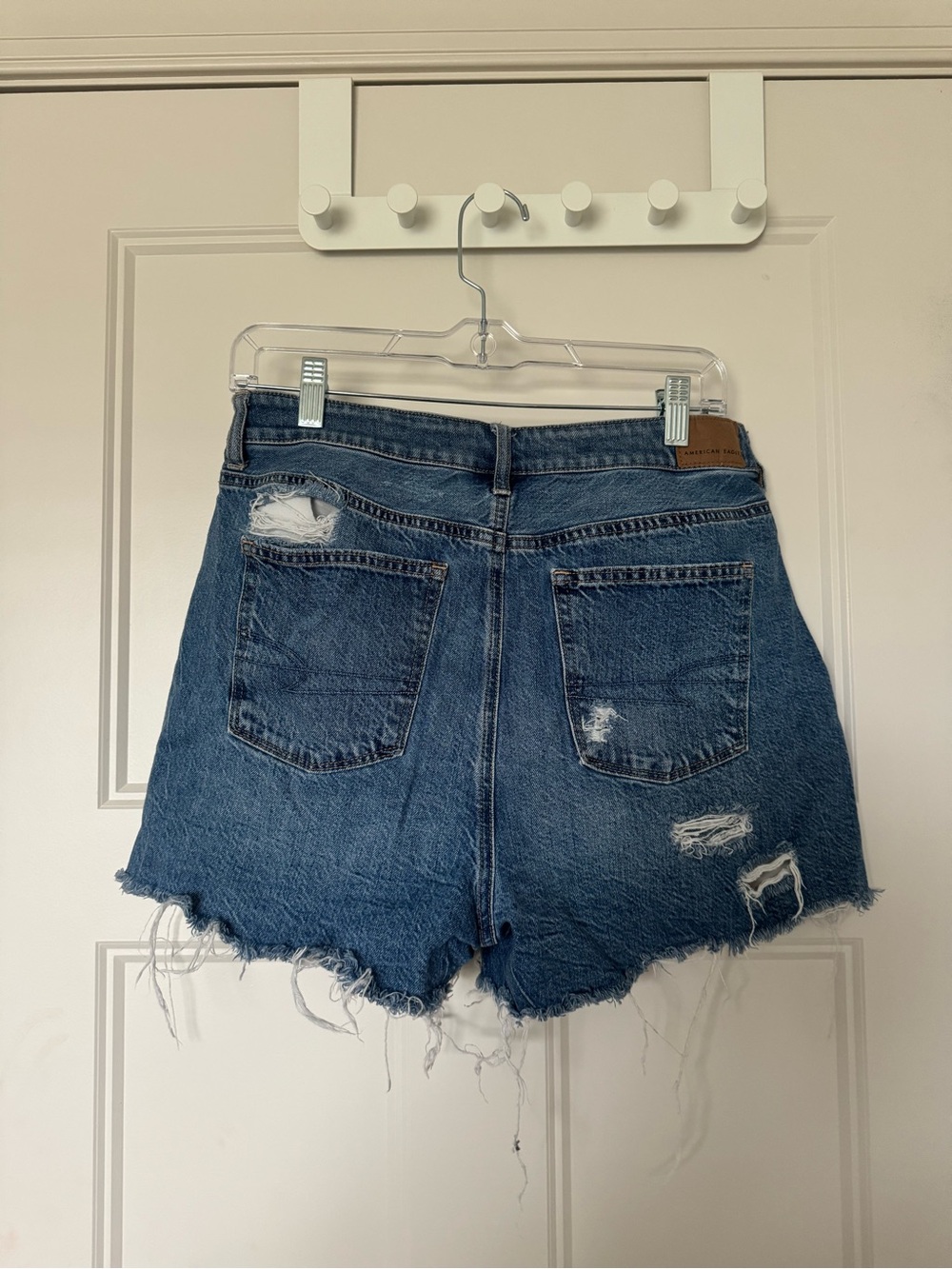 High-Rise Distressed Denim Shorts in Blue
